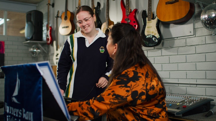 student and teacher in music class