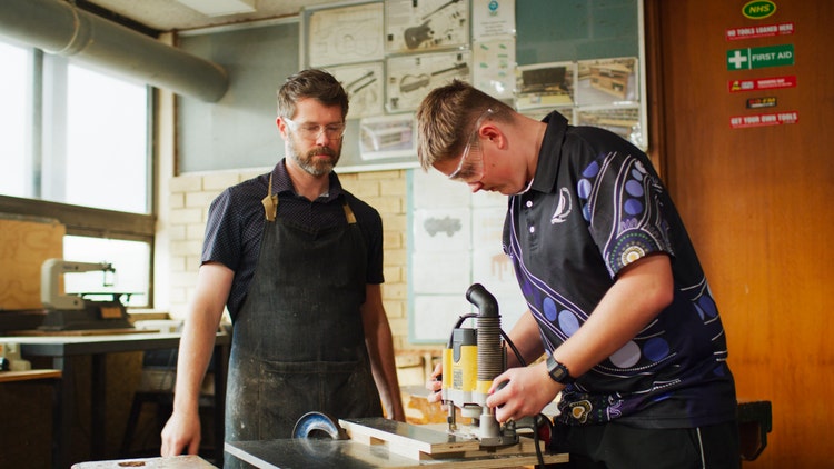 student and teacher in woodworking class